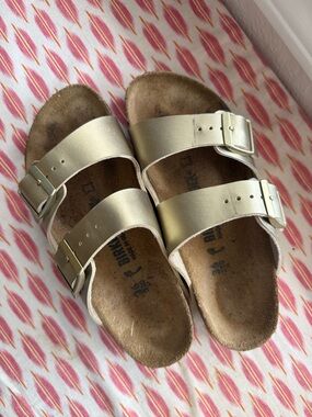 Birkenstock women’s Arizona Two-Strap Sandals in Metallic Gold size 36